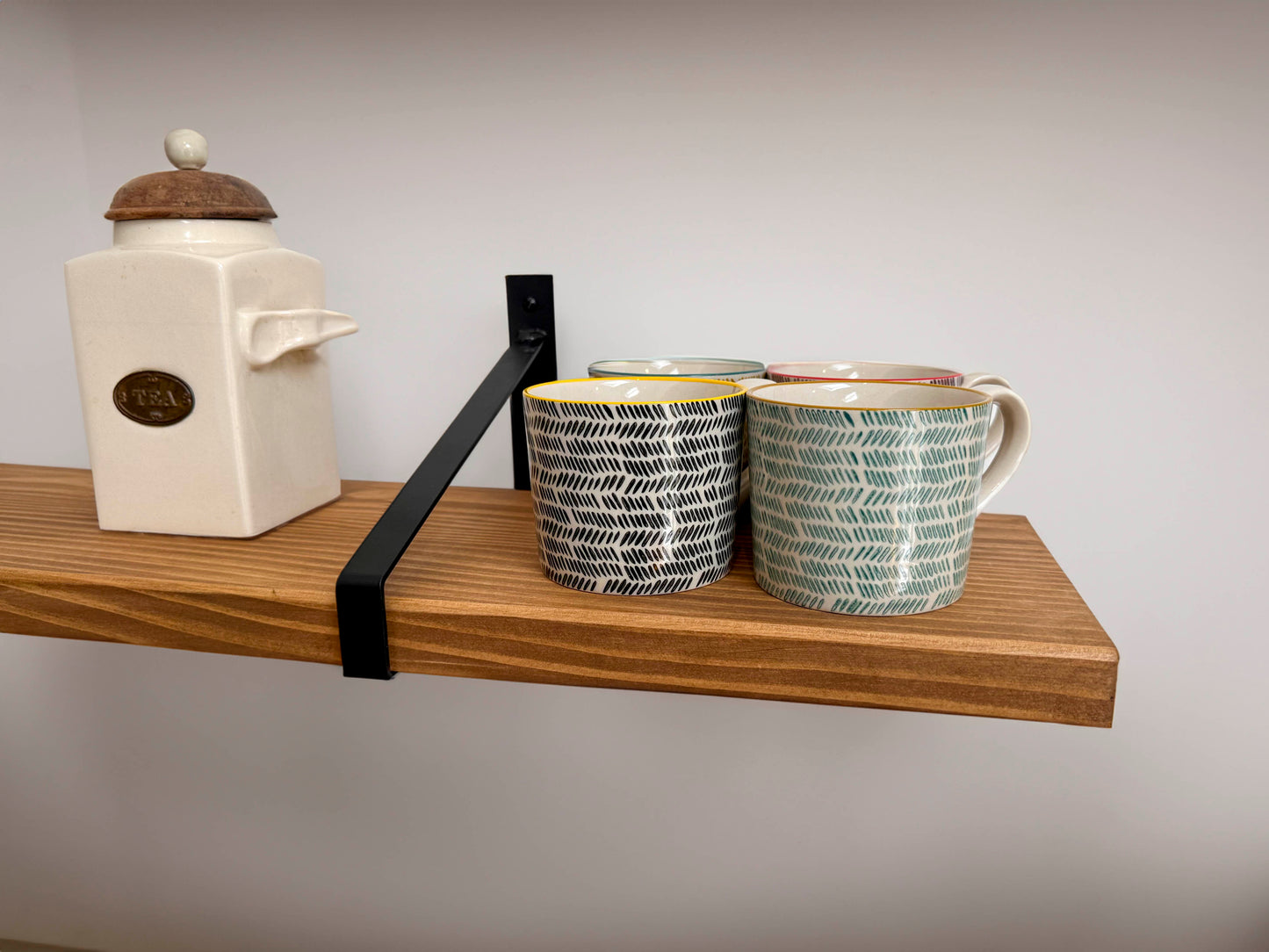 Wooden shelf on suspense bracket with Fiddes colour range
