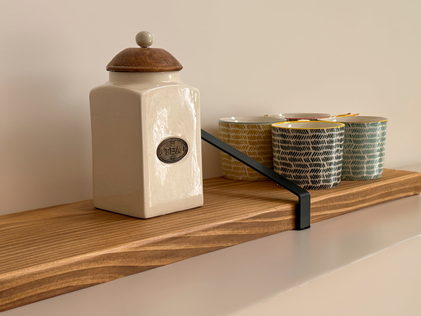 Wooden shelf on suspense bracket with Fiddes colour range