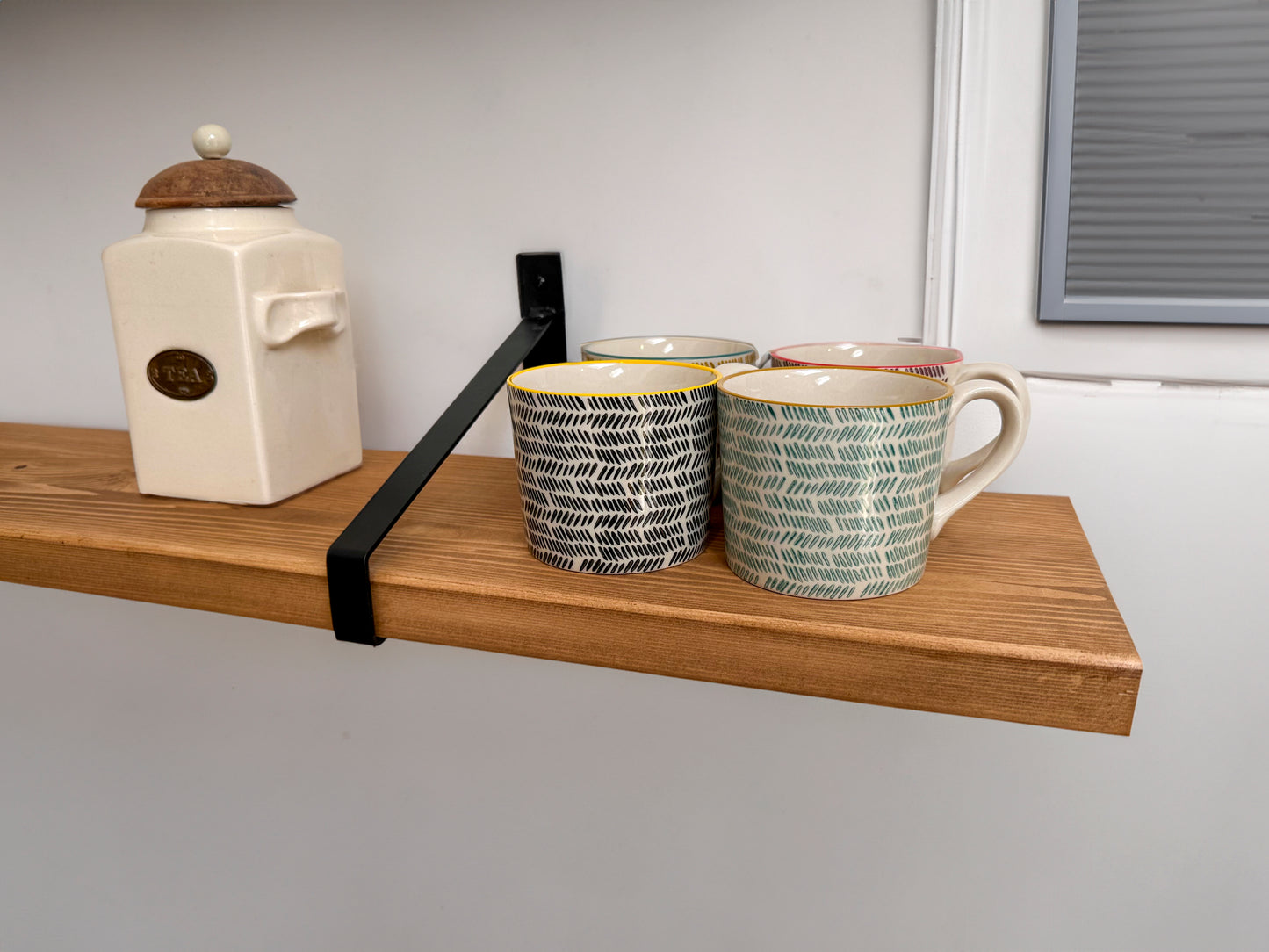 Wooden shelf on suspense bracket with Fiddes colour range