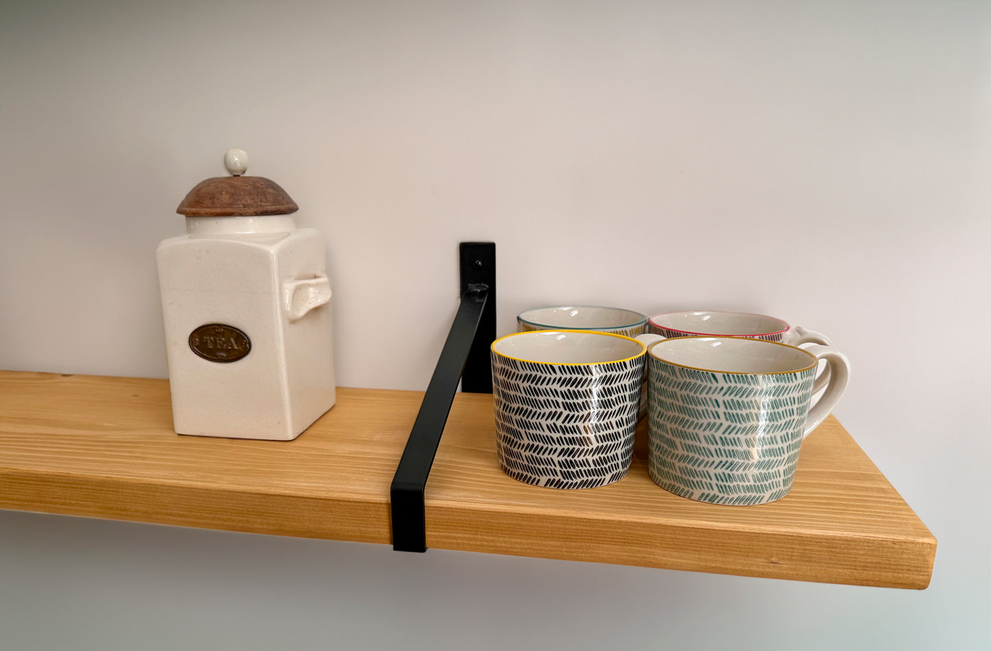 Wooden shelf on suspense bracket with Fiddes colour range